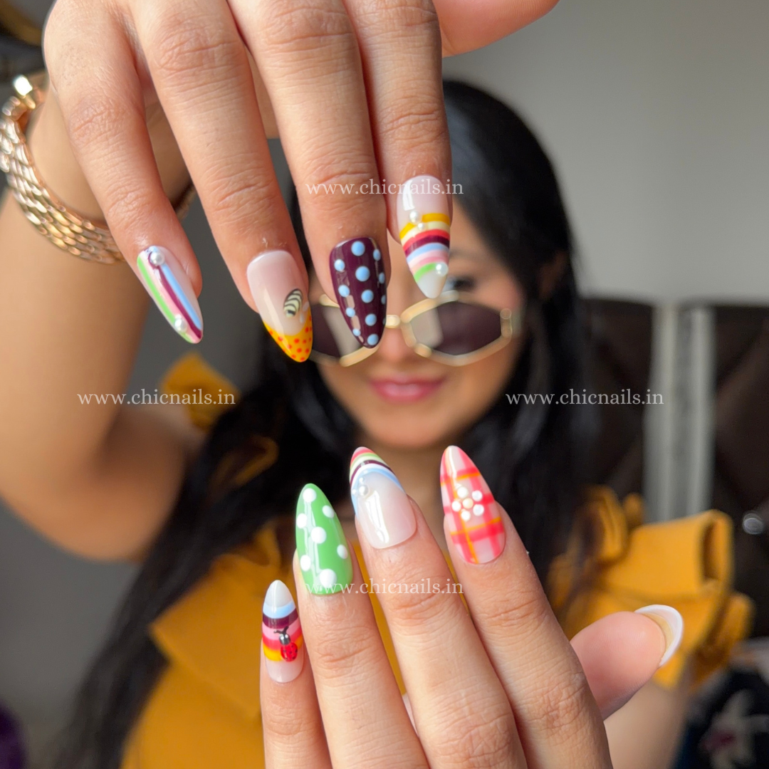 Colorful BuzzBloom summer press-on nails with ladybug, honeybee, polka dots, and bright floral-inspired design by Chic Nails India