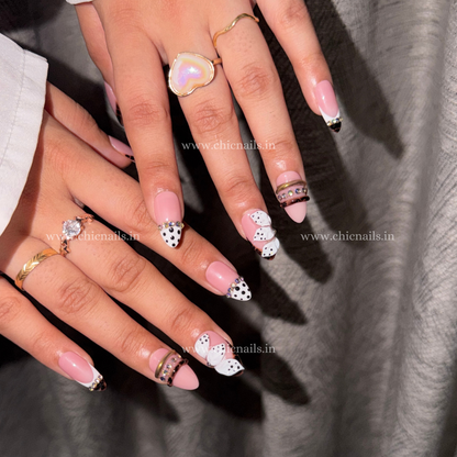 Pink coquette press-on nails with 3D flower, rhinestones, bangle nail rings, polka dots, and zebra print design by Chic Nails India