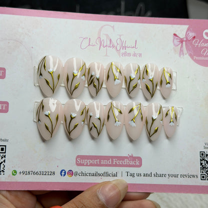 Petaluxe nude press on nails with gold floral vine and white flower nail art by Chic Nails India