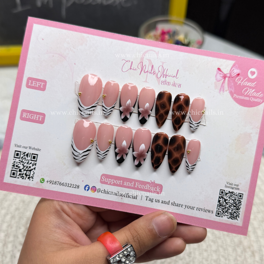Safari Chic press-on nails featuring zebra French tips, leopard print accents, nude ombre base, and floral nail art design, displayed on Chic Nails packaging.
