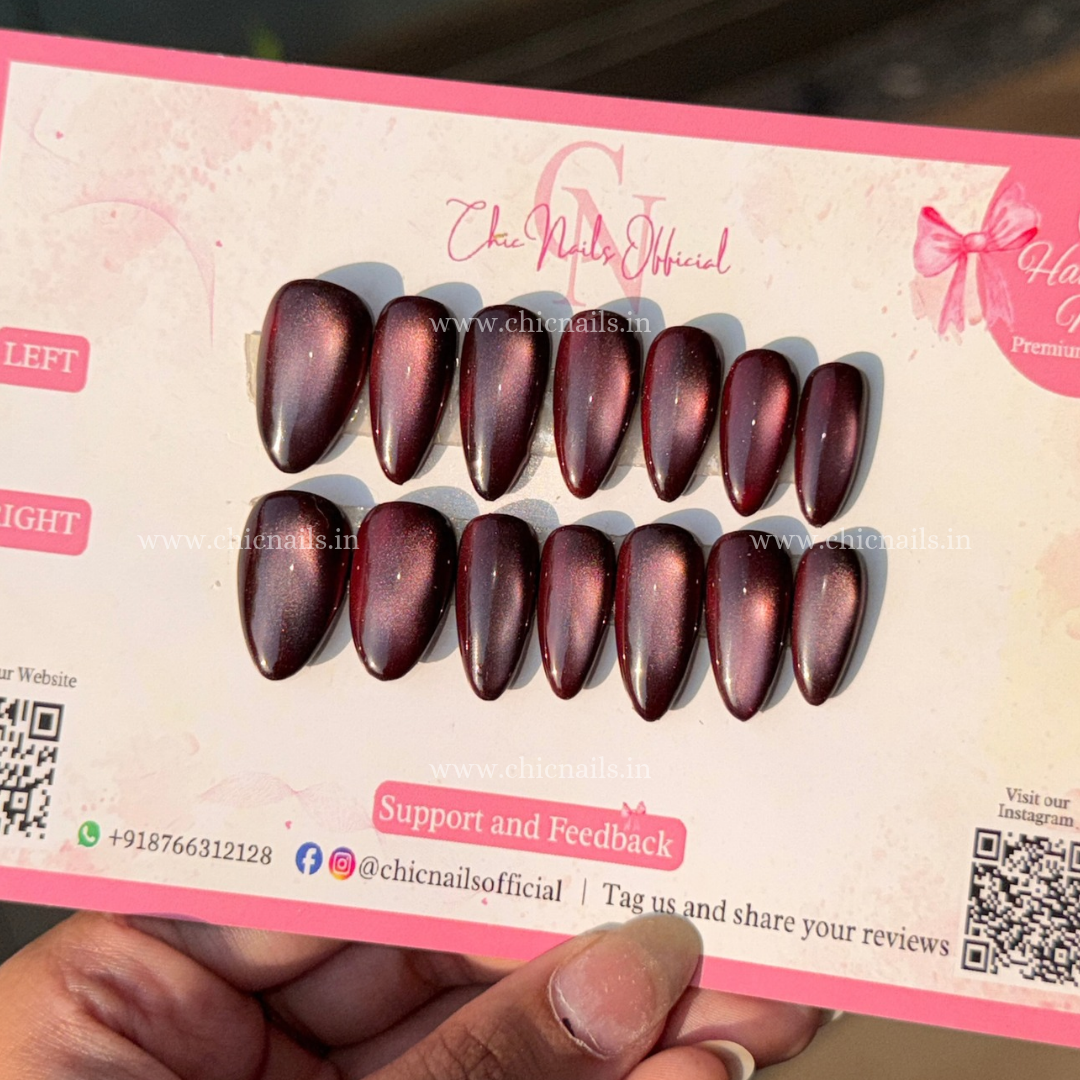 Wine Magic dark red magnetic cat-eye press-on nails with a glossy wine finish and glowing effect by Chic Nails Official.