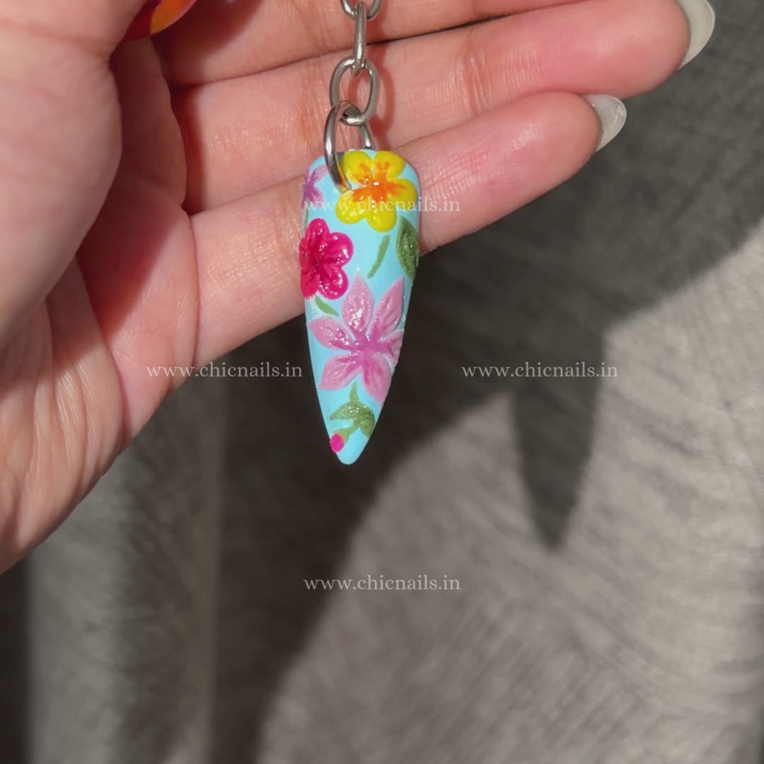 Bloomstitch floral nail keychain by ChicNails India, featuring blue base and colorful embroidered-style nail art