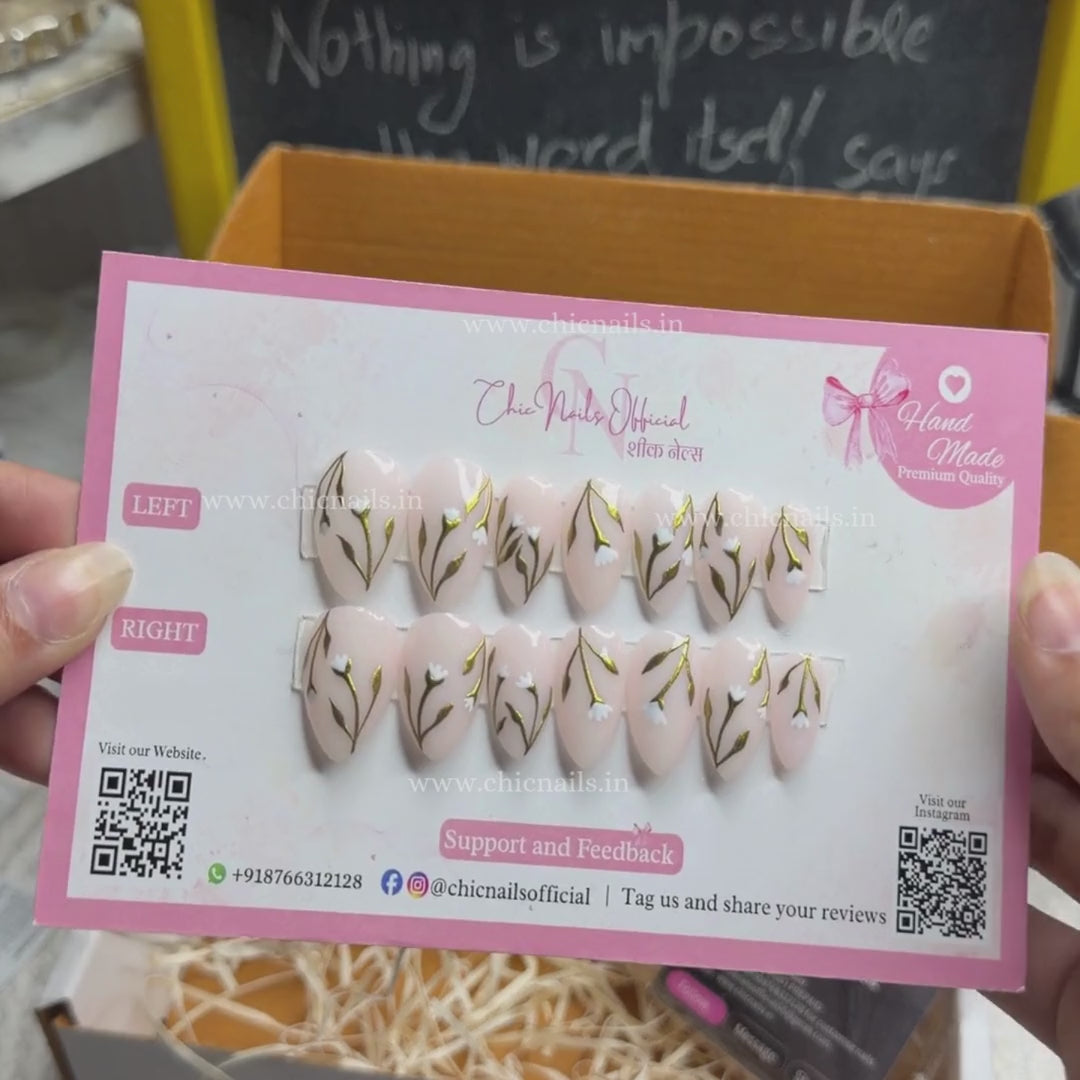 Petaluxe nude press on nails with gold floral vine and white flower nail art by Chic Nails India
