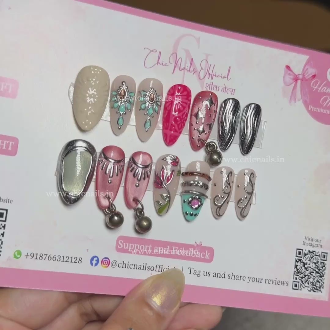 Garba Glam Navratri press-on nails featuring hanging accessories, chrome and cat-eye nail art by Chic Nails Official